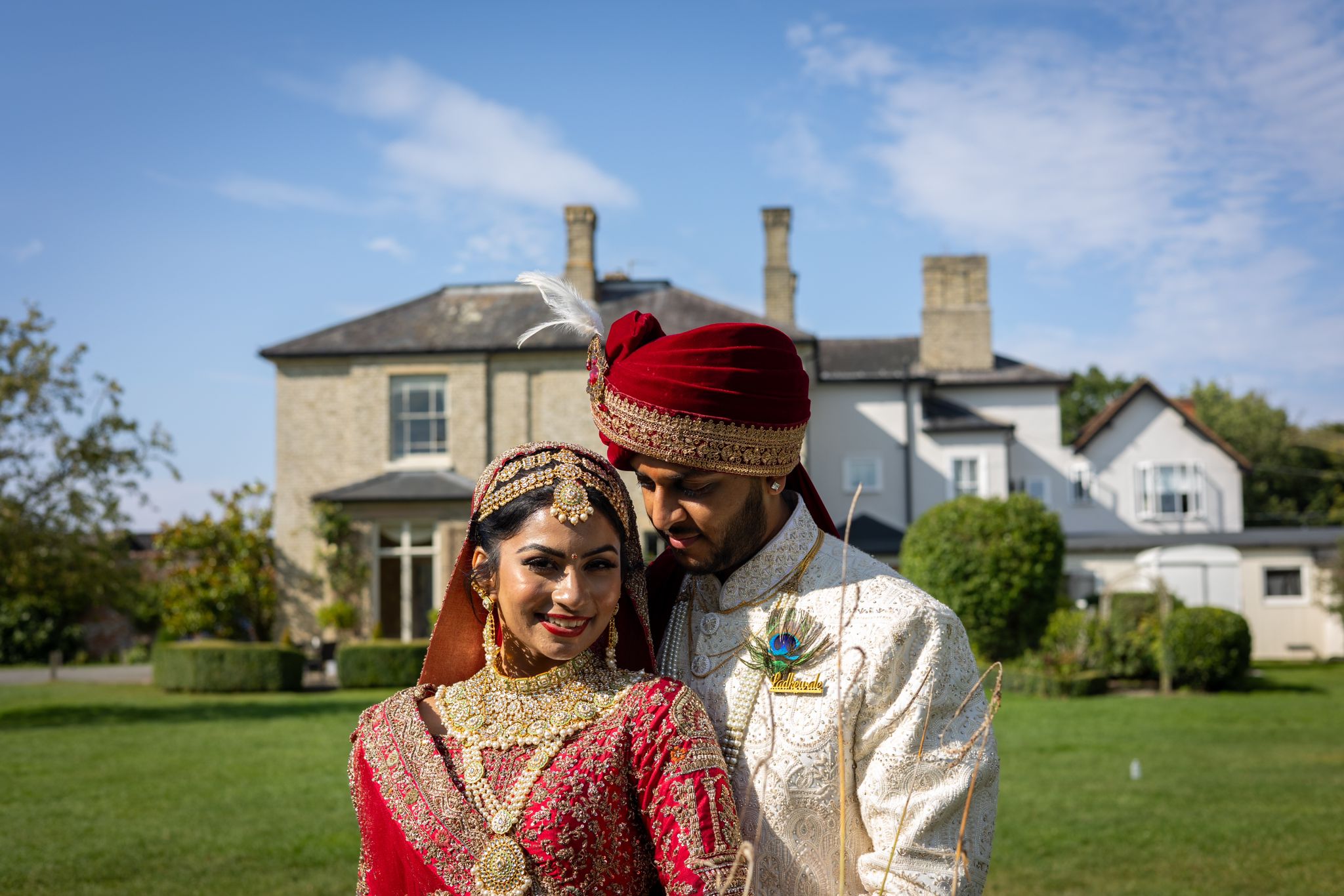 Silhouette of an Indian couple on their wedding day with orange skies behind them.